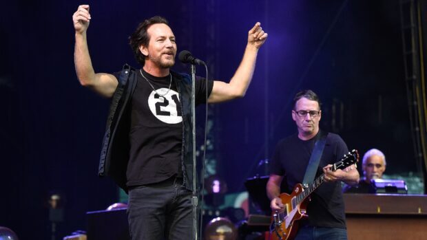 Pearl Jam performs energetically during a concert with band members playing instruments, 2K Desktop Wallpaper