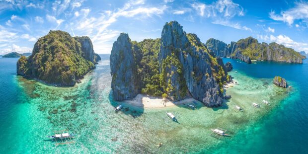 Stunning limestone cliffs and clear turquoise waters of a tropical island in the Philippines