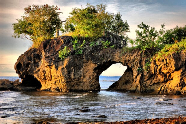Natural rock formation with greenery in the Philippines coastline