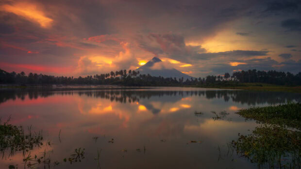 Stunning volcano landscape with a calm lake and vibrant sunset in Philippines