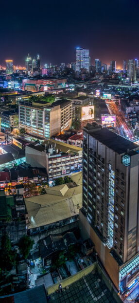 Night view of a busy cityscape in Philippines with illuminated buildings and streets