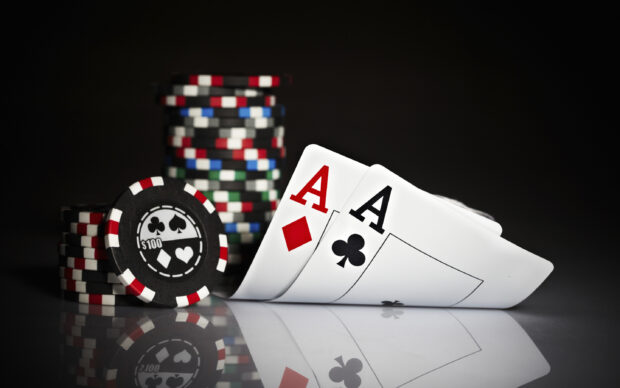 Two aces and poker chips on the table representing poker game chips