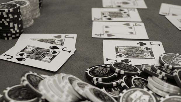A close up view of poker chips and playing cards on a poker table showing a poker game setup