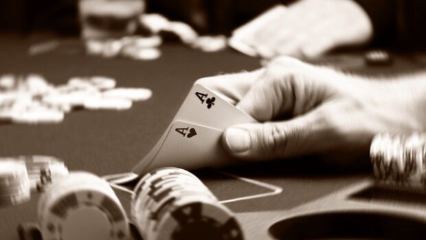 A poker player holding two aces during a high stakes poker game