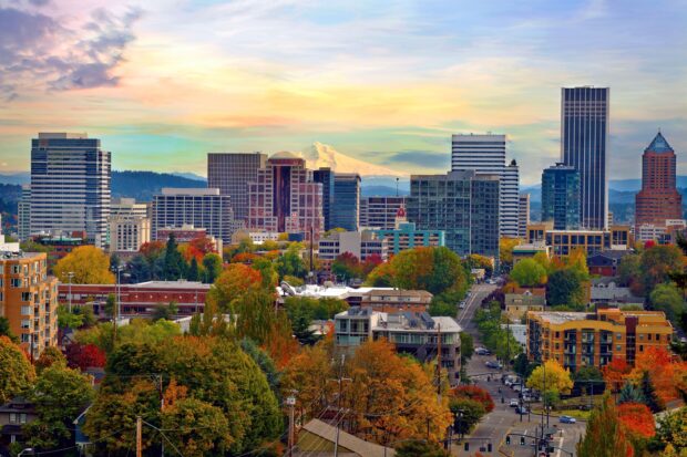 Autumn view of Portland skyline with colorful trees and Mount Hood in the distance