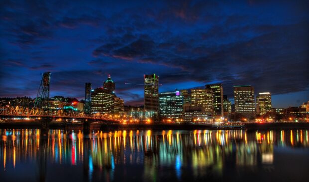 Nighttime cityscape with Portland skyline reflecting on the river