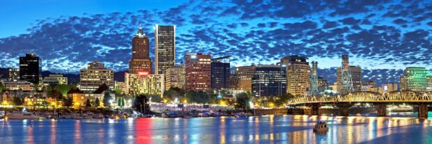 Portland skyline with colorful city lights reflecting on the water at dusk
