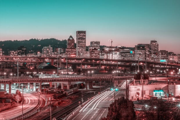 Portland skyline with illuminated roads and city buildings at dusk