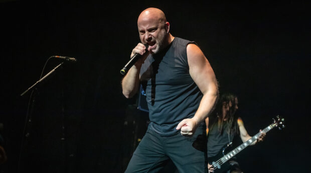 A singer passionately performs with a microphone during a Disturbed band concert, HD Desktop Wallpaper
