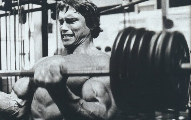A man performs an intense powerlifting exercise with a heavily loaded barbell, HD Desktop Wallpaper