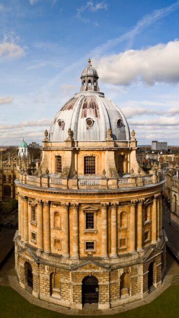 A historic Radcliffe Camera building stands prominently at Oxford University under a partly cloudy sky, HD Mobile Wallpaper