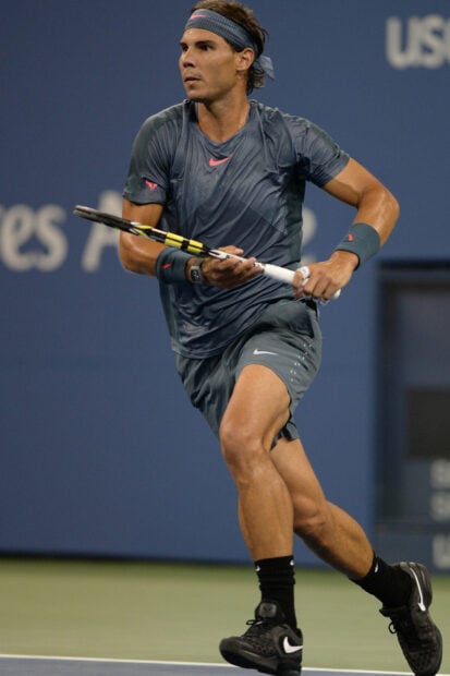 Rafael Nadal is focused during a tennis match hitting a backhand shot, HD Mobile Wallpaper