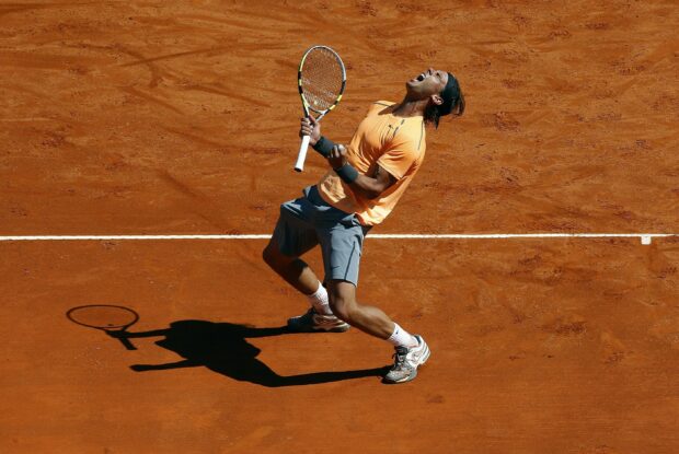 Rafael Nadal celebrating passionately during a tennis match on a clay court, 2K Desktop Wallpaper