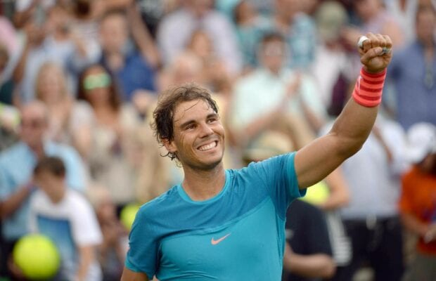 Rafael Nadal celebrating a tennis match with a raised fist and smiling happily, HD Desktop Wallpaper