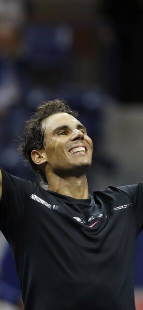 Rafael Nadal celebrating triumph with arms raised after a tennis match, HD Mobile Wallpaper