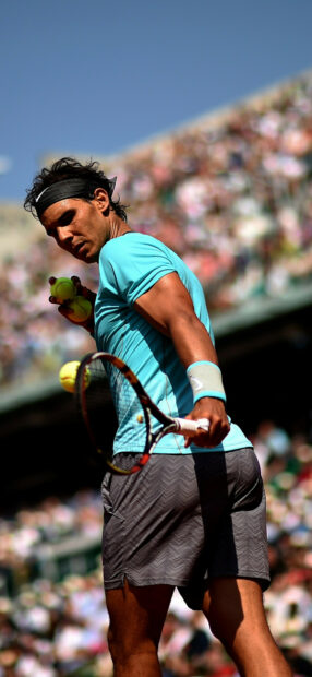 Rafael Nadal holds tennis balls preparing to serve during a match, HD Phone Wallpaper