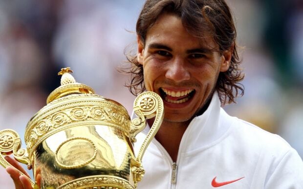 Rafael Nadal holding a large golden trophy with a joyful expression, 2K Desktop Wallpaper