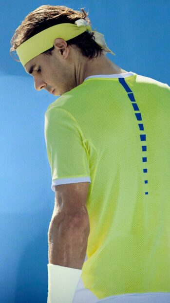 Rafael Nadal wears yellow sportswear during a match with blue sky background, HD Mobile Wallpaper