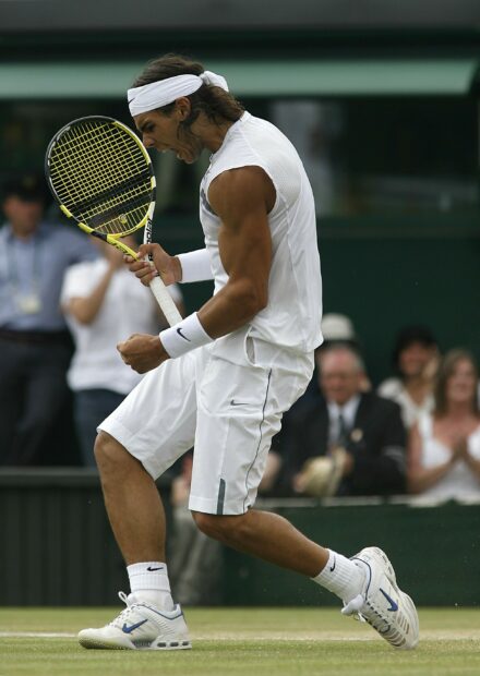 Rafael Nadal shows intense emotion during a tennis match on grass court, 2K Desktop Wallpaper