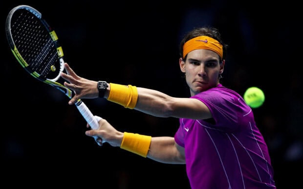 Rafael Nadal focused on hitting the ball during a tennis match, 2K Desktop Wallpaper