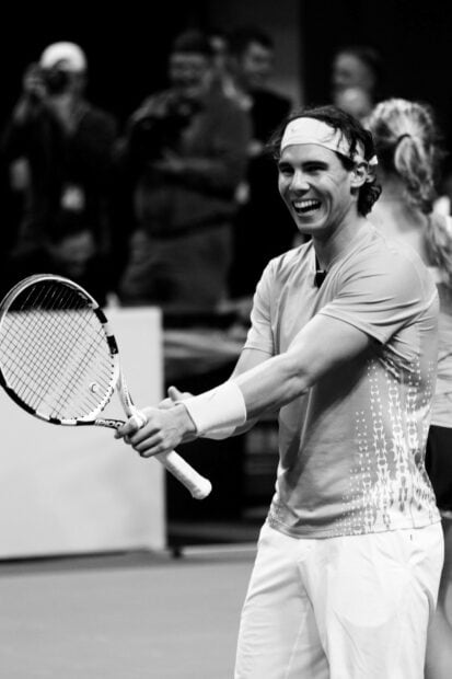 Rafael Nadal is enjoying a friendly tennis match holding a racket, HD Phone Wallpaper
