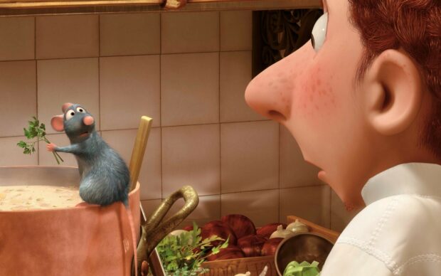 A rat holding herbs surprised by a chef in a kitchen from Ratatouille