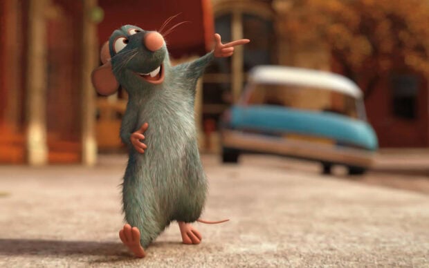 Ratatouille character standing and pointing in a city street scene with a vintage car in the background