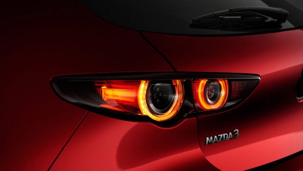 The image shows a close up of red Mazda 3 rear lights and badge, 4K Desktop Wallpaper