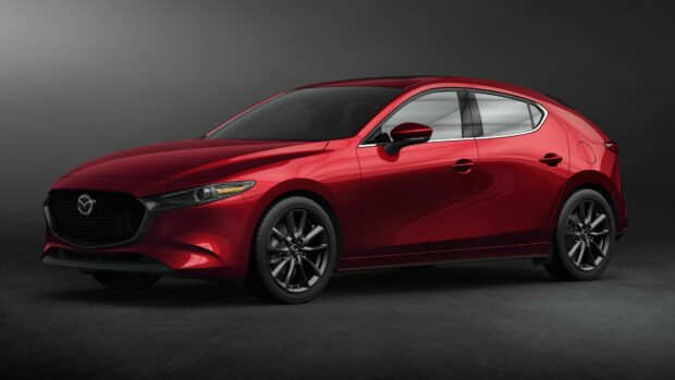 A red Mazda car is shown in a studio setting with a sleek design and black rims, 4K Desktop Wallpaper