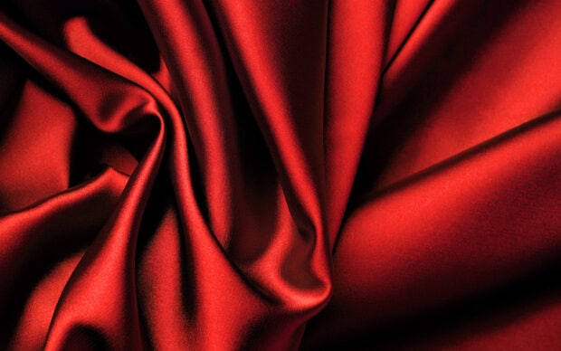 Red silk fabric draped with smooth and shiny texture in rich color, 2K Desktop Wallpaper