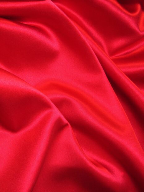 Smooth red silk fabric with gentle folds captured in detail to show rich color and shine, 2K Mobile Wallpaper