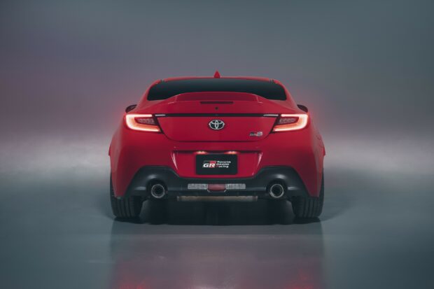 Red Toyota GR86 sports car rear view.