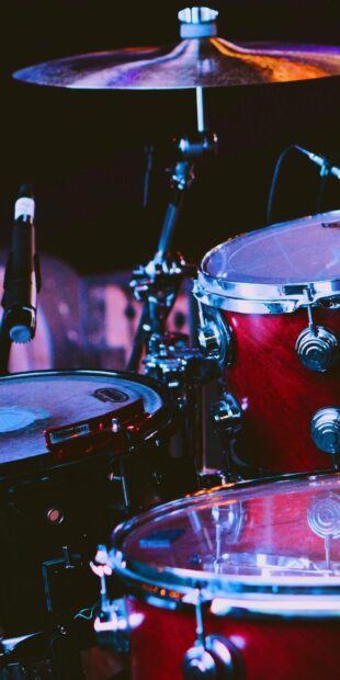 A detailed view of drums and cymbals with microphones on stage, HD Phone Wallpaper