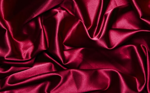 Smooth red silk fabric texture with natural light reflection, 2K Desktop Wallpaper