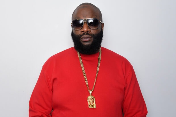 Rick Ross is wearing sunglasses and a red shirt with a gold chain around his neck, 2K Desktop Wallpaper