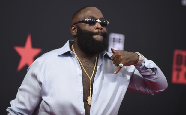 Rick Ross is wearing sunglasses and showing his jewelry in this image, 2K Desktop Wallpaper