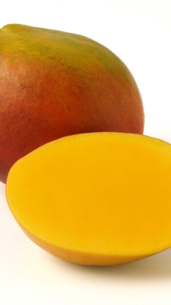 A ripe mango fruit with a half cut piece showing its bright yellow flesh, HD Phone Wallpaper