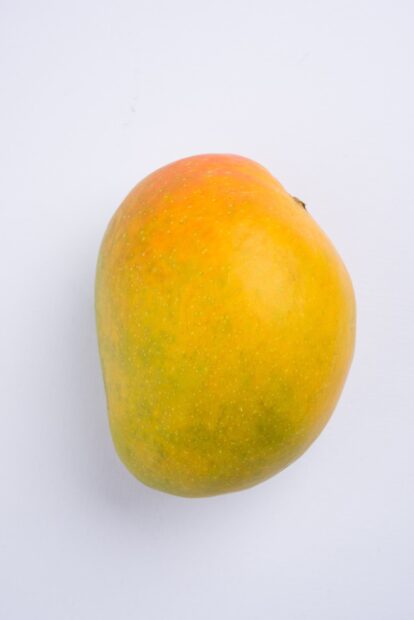 A ripe mango with a smooth red and yellow surface is displayed against a white background, HD Mobile Wallpaper