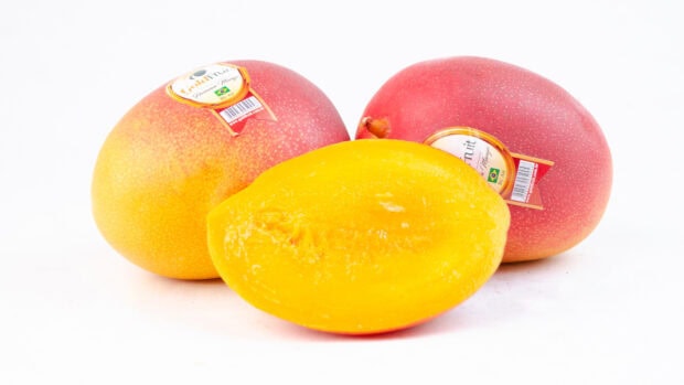 Fresh mangoes with bright yellow flesh and tags on skin, HD Desktop Wallpaper
