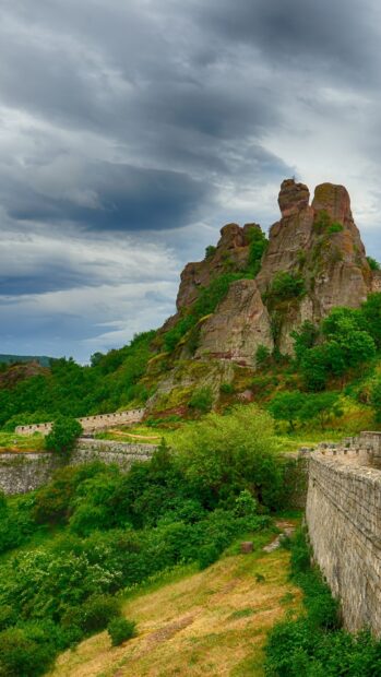 Bulgaria Wallpapers feature rocky hills and green trees under a cloudy sky, HD Phone Wallpaper