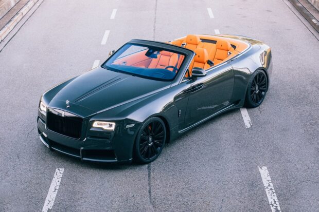 A Rolls Royce Dawn with black exterior and orange seats parked on the road, HD Desktop Wallpaper