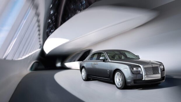 A sleek Rolls Royce Ghost car is driving through a modern architectural tunnel, HD Desktop Wallpaper