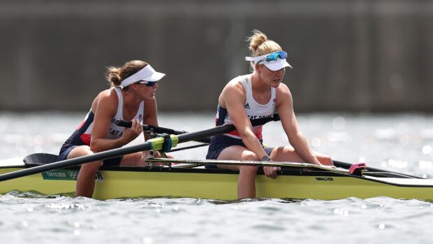 Two female athletes rowing a double scull boat during a competition on water