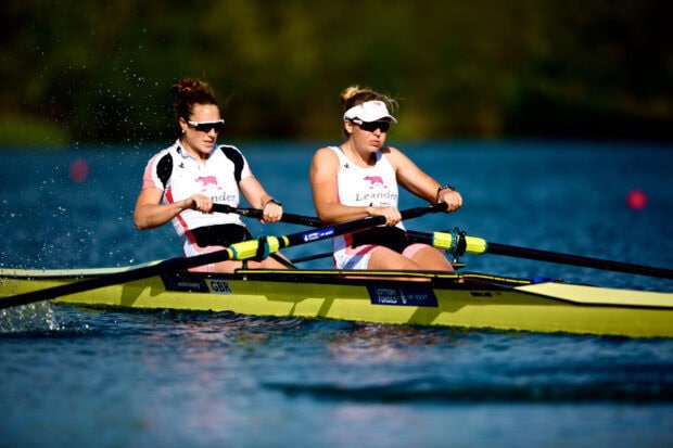 Two women rowing in a sleek boat showing the power of rowing sport
