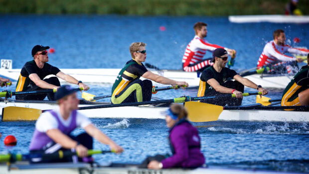 A rowing team training intensely on the water during a competition