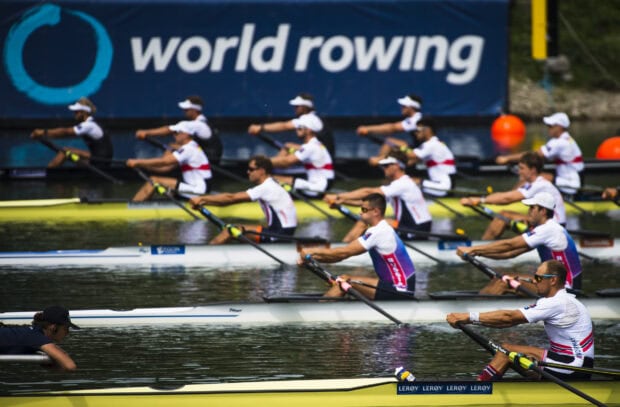 Competitive rowing teams racing on water during a world rowing event