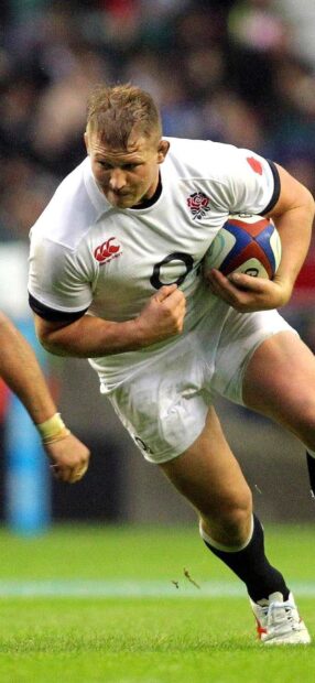 A rugby league player runs intensely while holding the ball during a match, HD Mobile Wallpaper