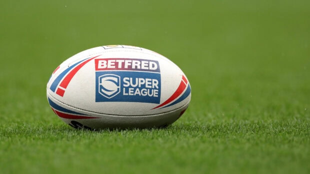 A rugby league ball lies on a well maintained green grass field ready for play, HD Desktop Wallpaper