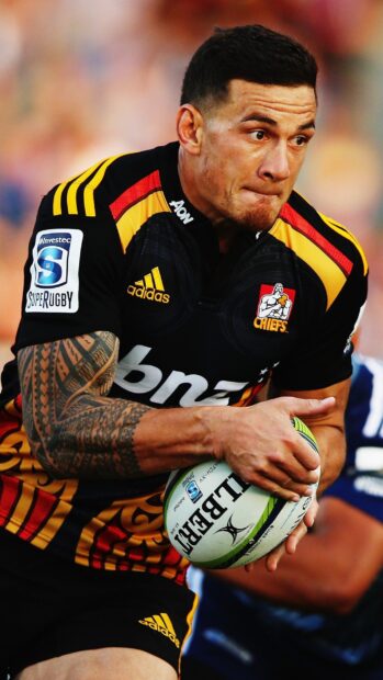 A focused rugby league player holding the ball tightly during a game, 2K Mobile Wallpaper