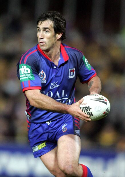 A rugby league player prepares to pass the ball during a match, HD Desktop Wallpaper